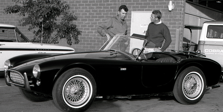 Carroll Shelby (left) and Steve McQueen discuss the Cobra.