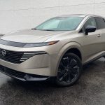 2025 Nissan Murano Platinum in Champagne Silver, front 3/4 view, rain,