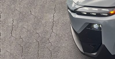 2026 Subaru Uncharted Sport in Metropolis Gray, Grille detail, headlights on, pavement, parking lot
